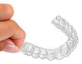 Hand holding the flexible, thin Pop On night guard